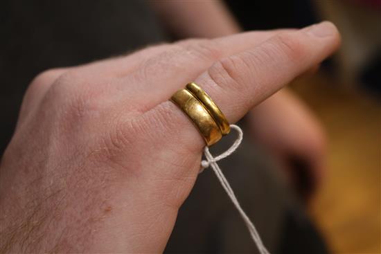 A 22ct gold wedding band and an 18ct gold wedding band.